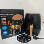 crna friteza pored originalne kutije
